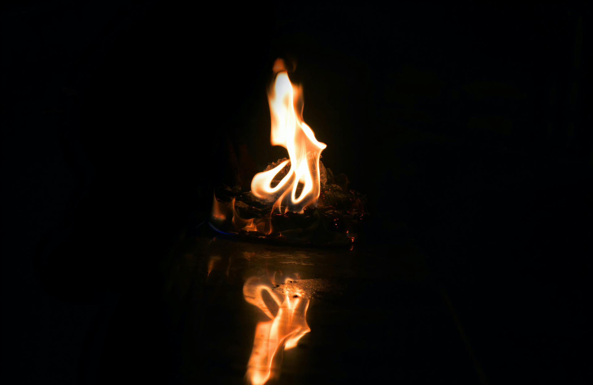 A flame with a reflection.