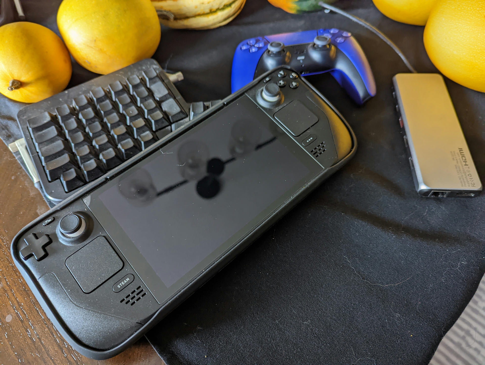 My Deck, alongside the peripherals I use with it: PS5 Controller, a USB-C hub, and an Ergodox.